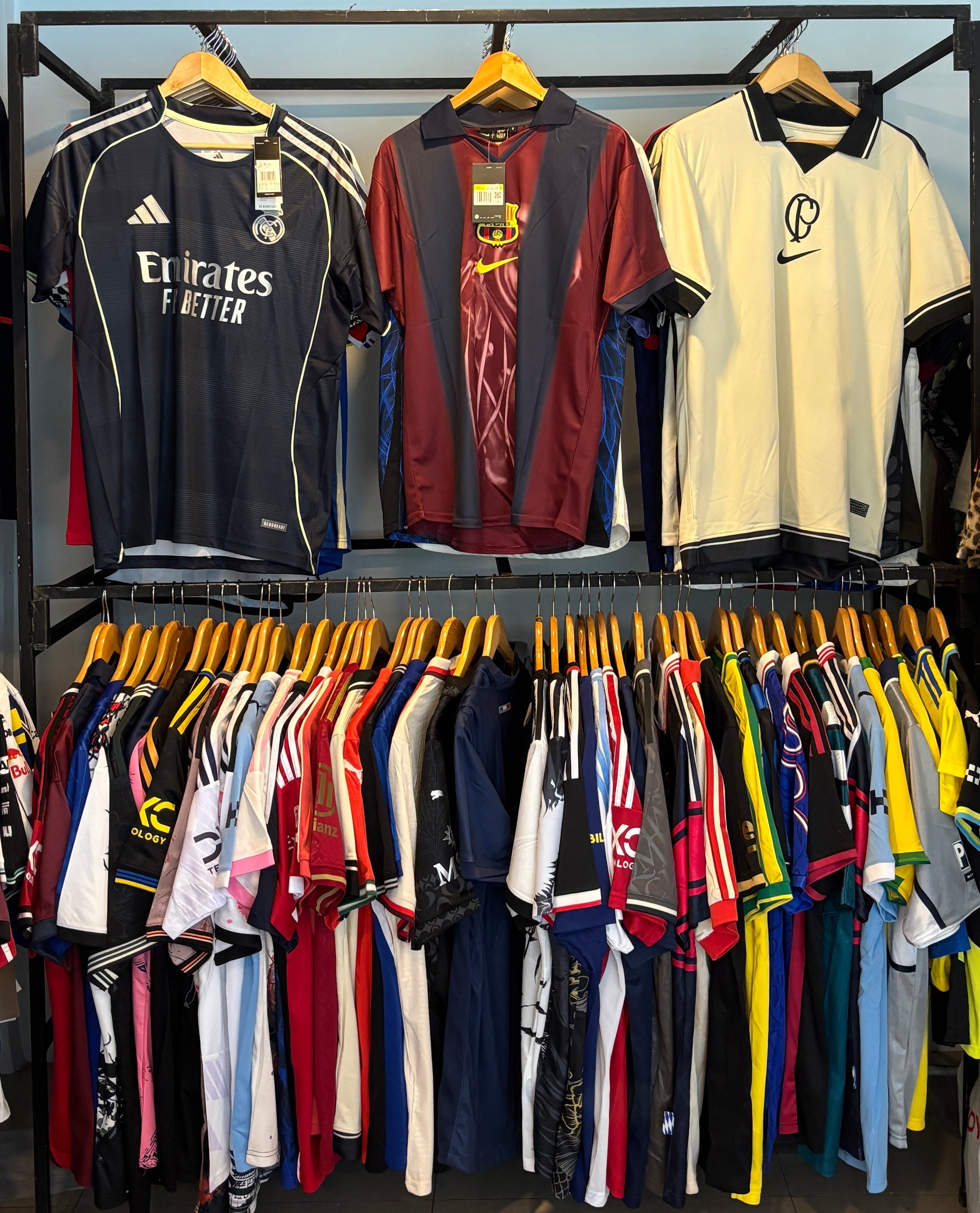 Display of various shirts on hangers in a store setting